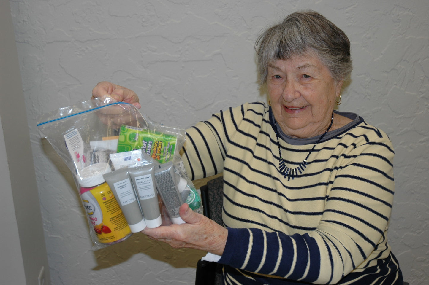 Senior holding a bag of hygiene products